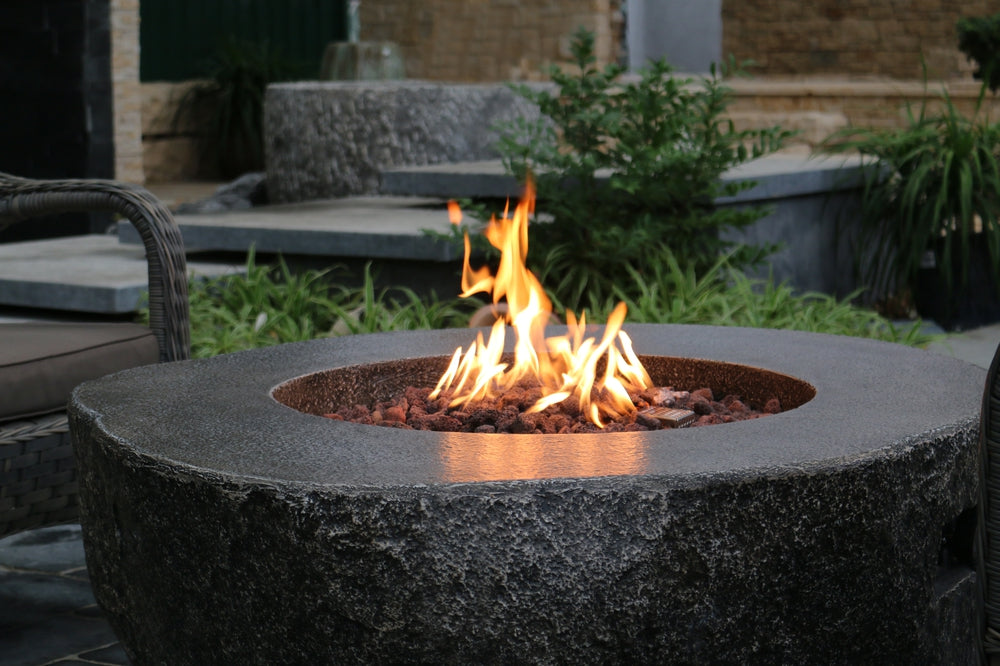 Circular stone firepit with flames, 50 inches, outdoor patio setting
