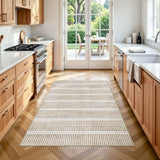 Beige and cream striped area rug on herringbone wood floor in kitchen