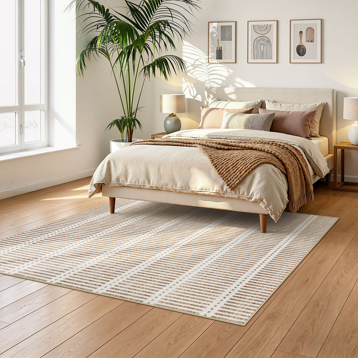 Beige and white striped area rug on wooden floor in bedroom with bed and palm plant
