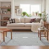 Black and white geometric patterned area rug on wooden floor in a living room