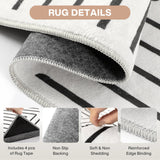 Close-up of a black and white geometric rug showing its reinforced edge binding, non-slip backing, and included rug tape