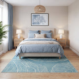 Blue leaf pattern area rug on wooden floor in bedroom with bed and nightstands