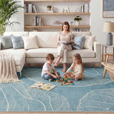 Light blue leaf-patterned rug in a living room with children playing on it