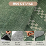 Close-up of green scolloped geometric rug showing backing, texture, and reinforced edge binding