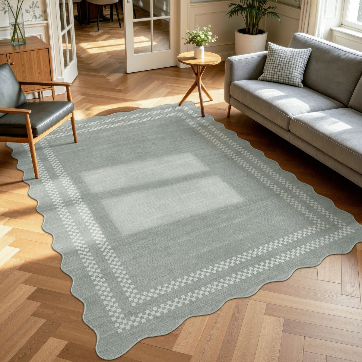 Scalloped grey area rug with white checkered border on wooden floor in living room