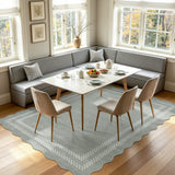 Scalloped light grey area rug with geometric pattern, shown in a dining room setting