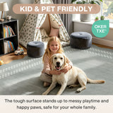 A girl and dog on a grey scalloped geometric rug in a child's room