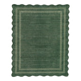 Scalloped green area rug with checkered border, viewed from above