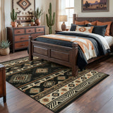 Southwestern patterned area rug in black, beige, and orange on hardwood floor in bedroom