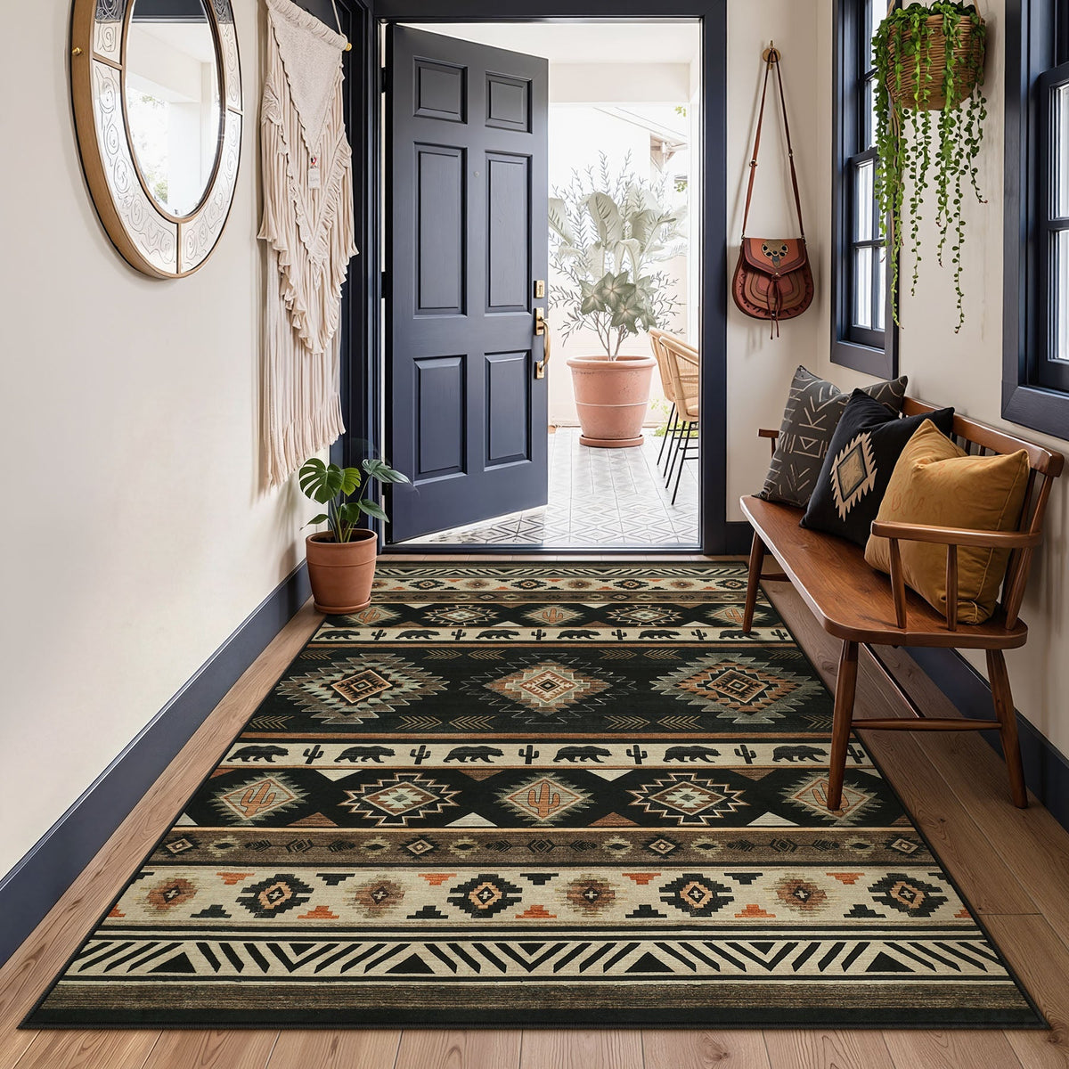 Southwestern patterned rug in beige, black, and brown on wooden floor near open door