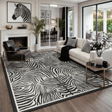 Black and white zebra print rug on wooden floor in modern living room with sofa and chair