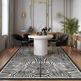 Black and white zebra print rug on wooden floor in dining room with round table and chairs