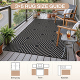 Black geometric patterned jute rug on wooden deck with chairs and plants, 91 x 152 cm / 36 x 60 inches