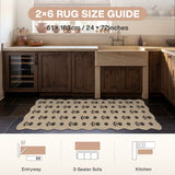 Floral jute rug in beige with black pattern, 61 x 183cm, shown in kitchen on dark tile floor