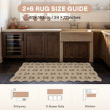 Floral jute rug in beige with brown pattern, 61 x 183cm, shown in kitchen on dark tile floor