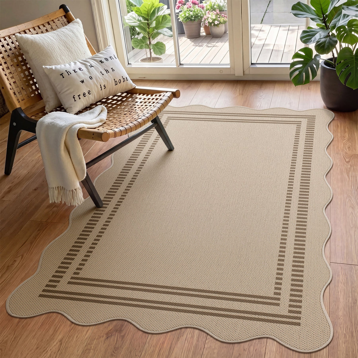 Beige scalloped jute rug with brown border on wooden floor near chair and plants