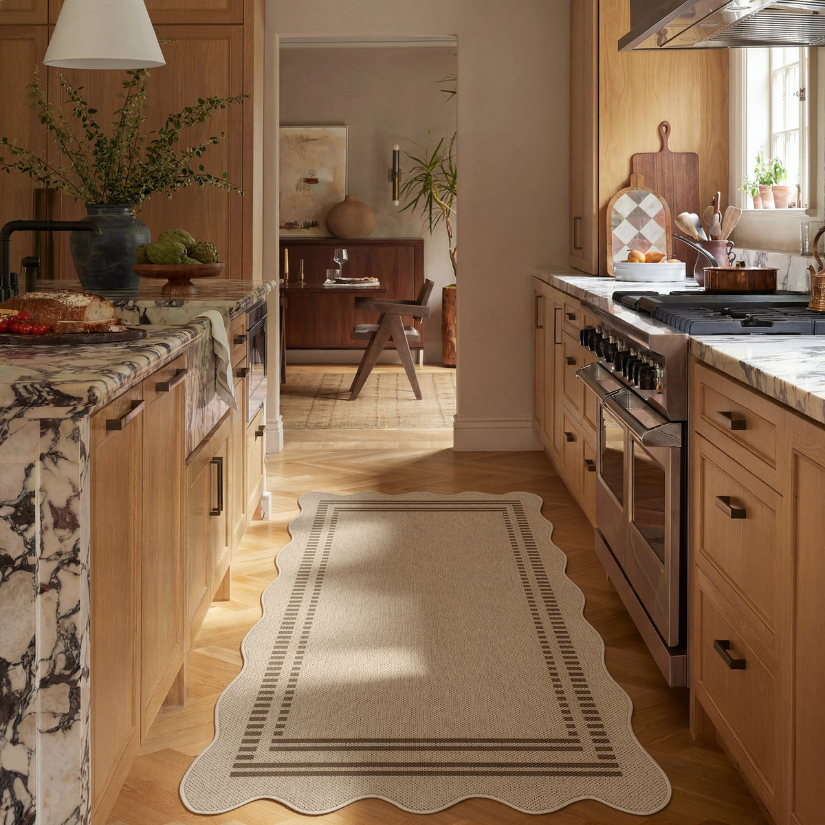Scalloped beige jute rug with dark border on wooden floor in kitchen