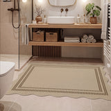 Beige scalloped jute rug with dark brown border on tiled bathroom floor
