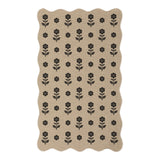 Beige jute rug with black floral pattern, scalloped edges, shown flat