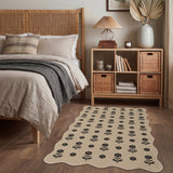 Black floral pattern on beige jute rug on wooden floor in bedroom
