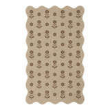 Beige jute rug with brown floral pattern, scalloped edges, shown flat on floor