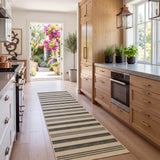 Striped jute runner rug in beige and dark grey on light wood floor in kitchen