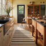 Striped jute runner rug in beige and dark gray, shown in a kitchen with wooden floors and cabinets