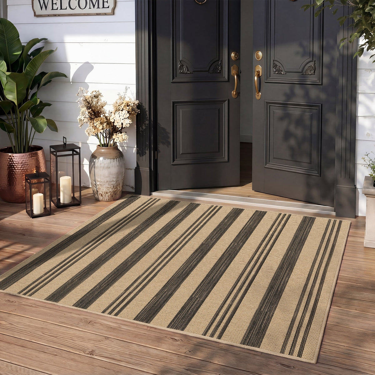 Striped beige and black jute rug on wooden porch near black front door