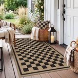 Black and beige checkered jute rug on wooden porch near door and wicker baskets