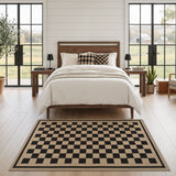 Black and beige checkered jute area rug on light wood floor in bedroom
