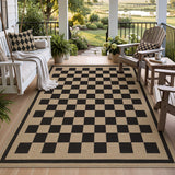 Black and beige checkered jute rug on a wooden porch with outdoor furniture