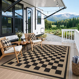 Black and beige checkered jute rug on wooden deck with chairs and mountain view