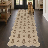 Beige jute runner rug with brown floral pattern, shown in hallway with golden retriever sitting on it