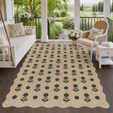 Beige jute rug with black floral pattern on wooden porch with white furniture