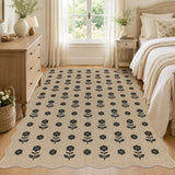 Black floral pattern on beige jute rug in a bedroom with wooden floors and furniture