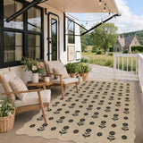 Black floral pattern on beige jute rug on wooden porch with chairs and plants