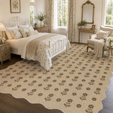 Beige floral jute rug with scalloped edge in a bedroom setting