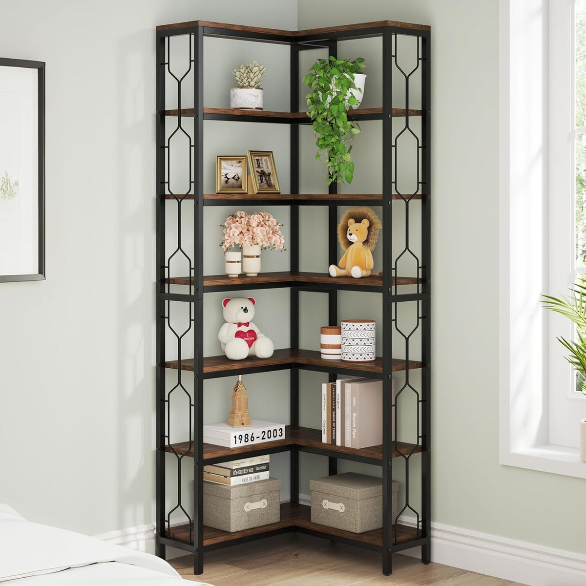 Black metal and wood corner bookcase with seven shelves, filled with books, plants, and decor in a bedroom