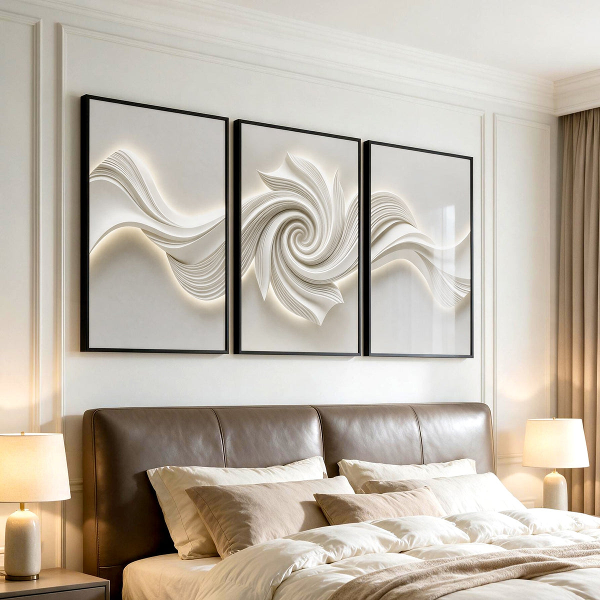 Three black-framed abstract canvas artworks with 3D textured swirls mounted above a bed in a bedroom