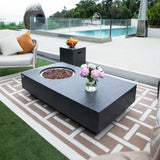 Dark grey rectangular fire pit table with fire bowl and pink flowers on patterned rug outdoors