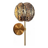 Brass wall sconce with textured smoky gray glass shade, shown from front angle