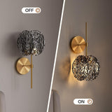 Brass wall sconce with smoky gray glass shade, shown off and on