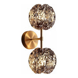 Gold wall sconce with two textured smoke glass globe lights, shown from front angle