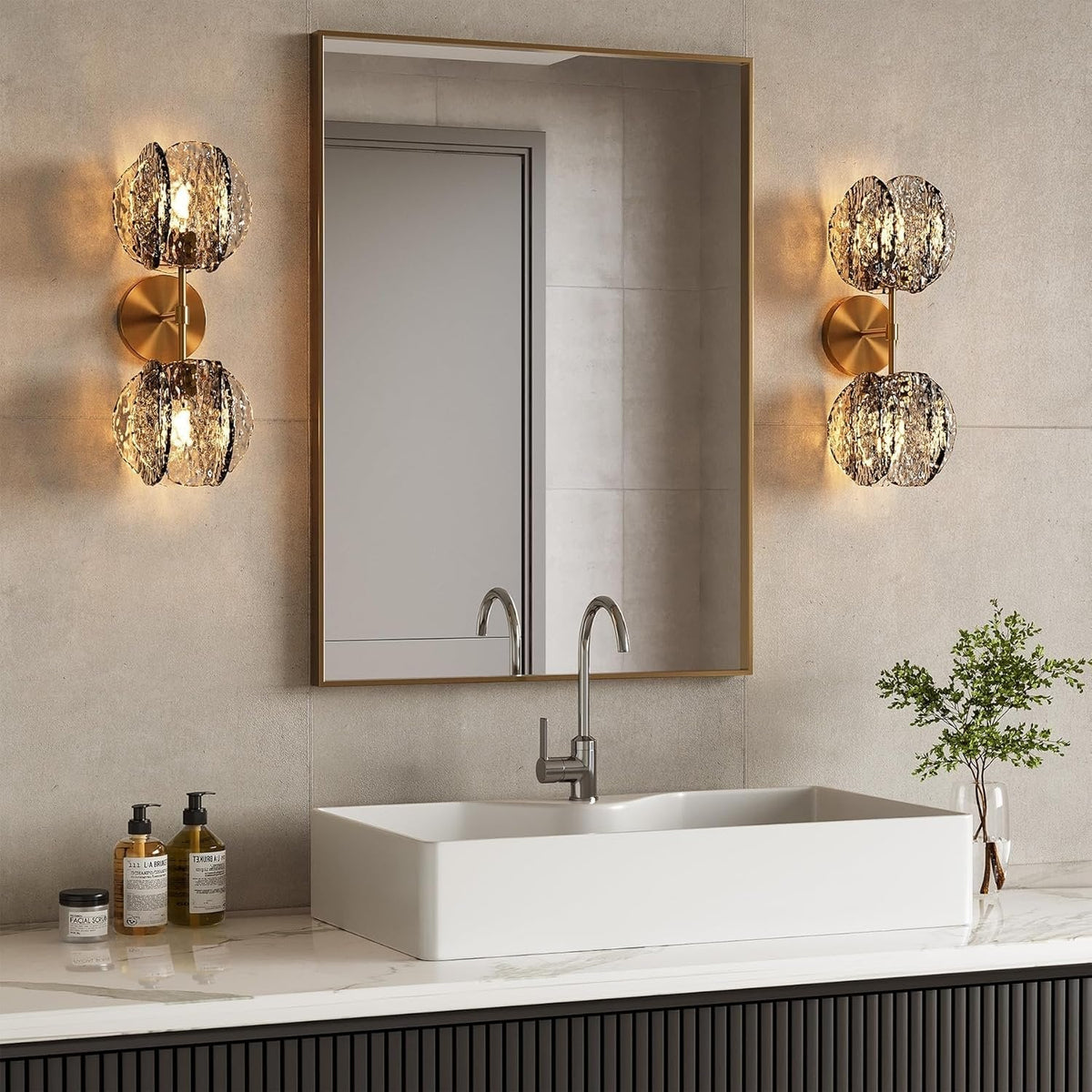 Gold wall sconce with two textured smoke glass globe lights mounted on bathroom wall