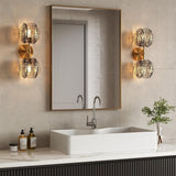 Gold wall sconce with two textured smoke glass globe lights mounted on bathroom wall
