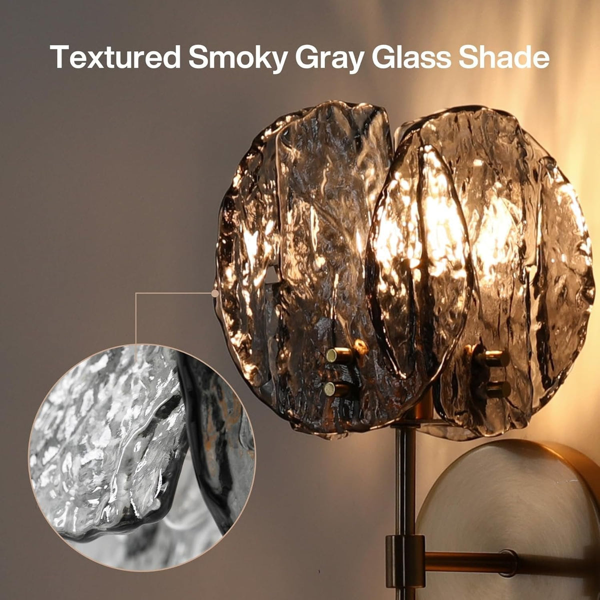 Gold wall sconce with two textured smoky gray glass shades, shown at an angle