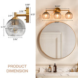Gold bathroom vanity light with three gray crackle glass shades, shown above a round mirror in a bathroom