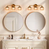 Gold bathroom vanity light with three gray crackle glass shades mounted above round mirrors