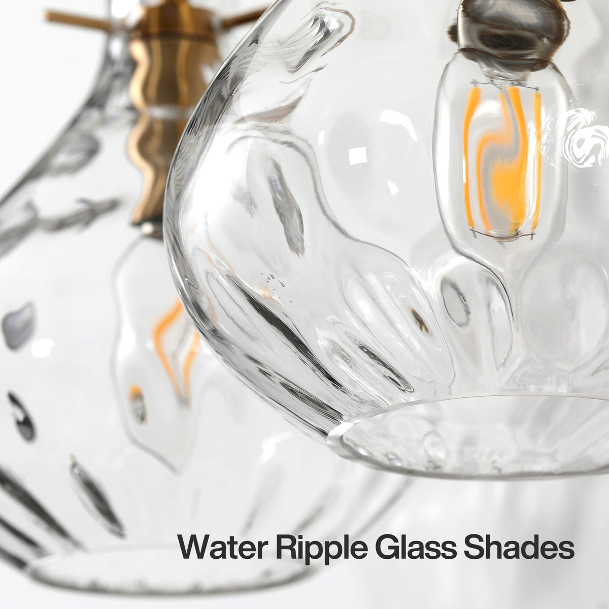 Close-up of three water ripple glass shades with brass accents and LED bulbs