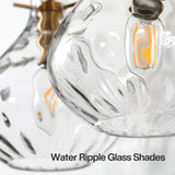 Close-up of three water ripple glass shades with brass accents and LED bulbs
